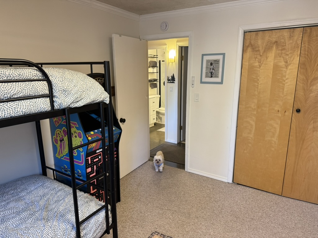 Bunk room view showing the Pac-Man arcade machine, closet and the bathroom just across the hall